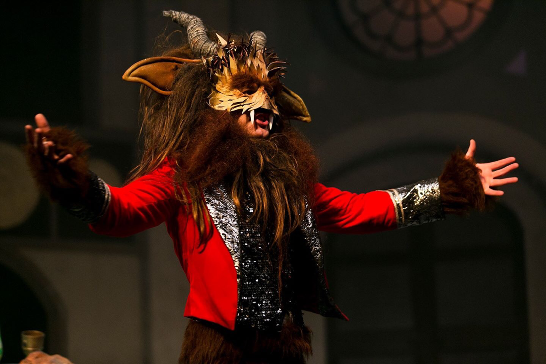 The Beast serenades Beauty in a red velvet jacket and textured mask with big ears and horns. Costumes designed by Alison Brown Costume Designer. 