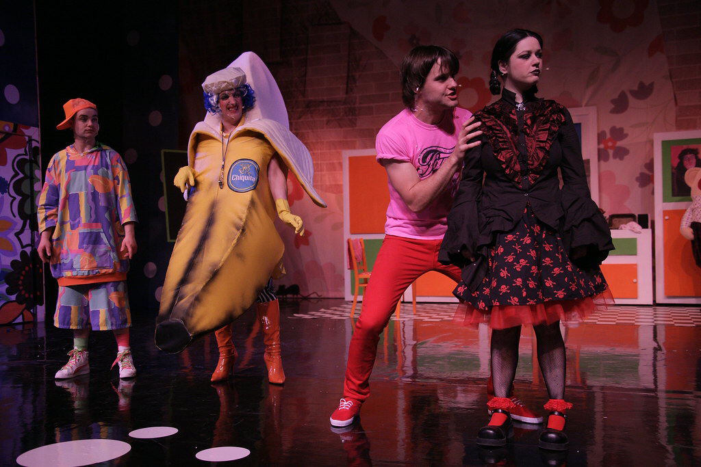 Johnny McKnight wears a large banana costume during a slapstick scene with 3 other actors on stage at the Macrobert Arts Centre.
